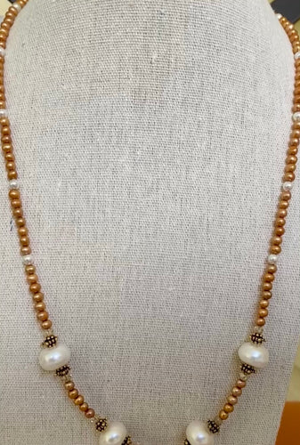 Necklace with white and caramel freshwater pearls and antique gold beads with crystals around them